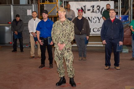 Capt. Torkelson and the Off-Yard Carriers Team line up to film a video congratulating the team on their efforts with the USS Gerald R. Ford (CVN 78) project.