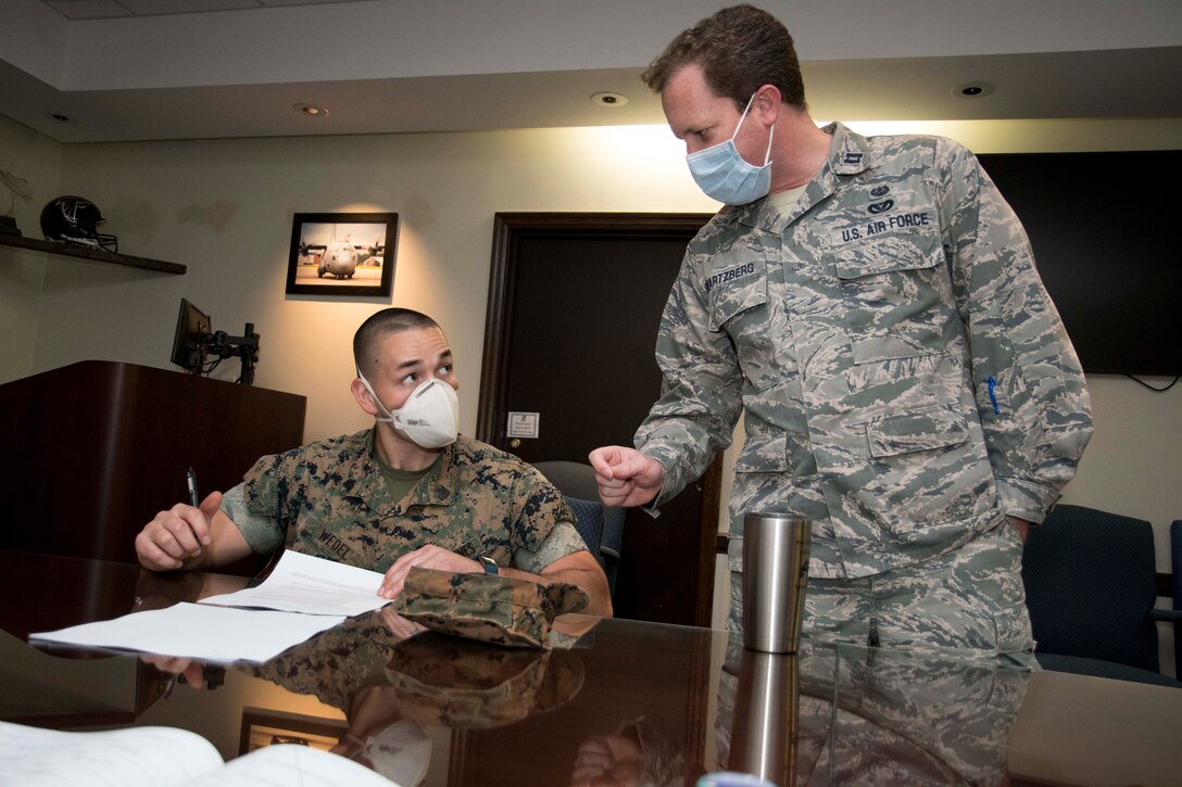 Capt. Greg Swartzberg, 94th Airlift Wing deputy staff judge advocate, helps a Marine fill out a legal form worksheet in the wing conference room at Dobbins Air Reserve Base, Ga. on April 9, 2020.