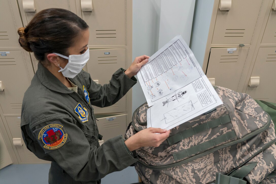 Senior Airman Emilie Canlas, 36th Aeromedical Evacuation Squadron aeromedical evacuation technician, reads over her checklist of assigned equipment April 9, 2020 at Keesler Air Force Base, Miss.