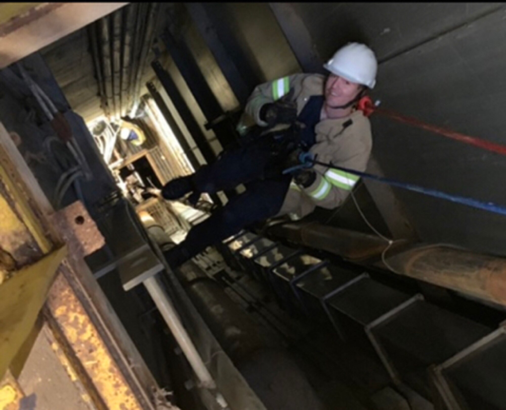 Brian Barnes, a rescue technician with Arnold Fire and Emergency Services, makes the almost 300-foot vertical descent into the J-4 silo to assist in retrieving the five Arnold Engineering Development Complex craftsmen on Feb. 29 at Arnold Air Force Base. (U.S. Air Force photo)