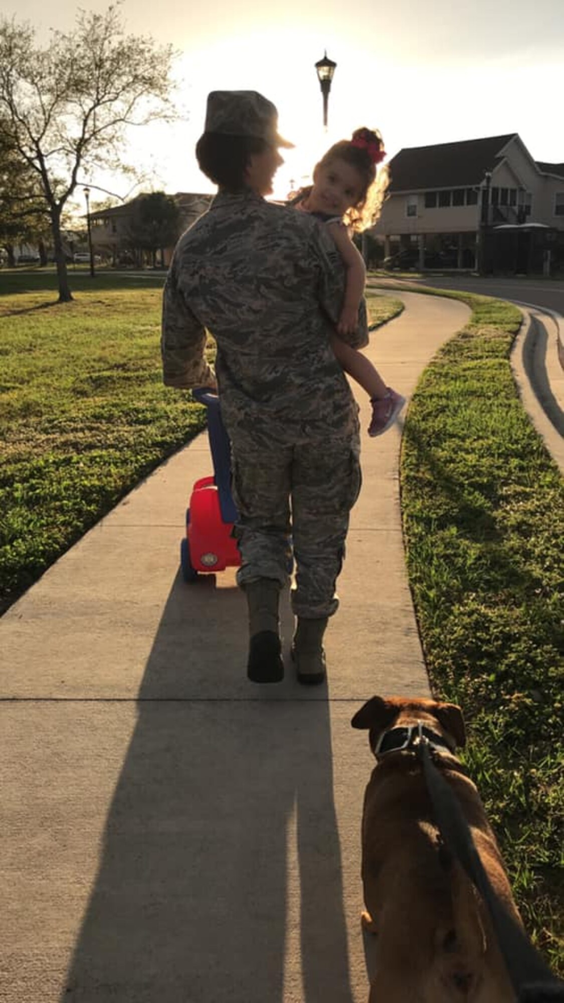 U.S Air Force Airman Staff Sergeant Heather Fejerang holds her daughter Isabel Fejerang while walking home at MacDill Air Force Base, Fla., February 2019. Staff Sgt. Fejerang practices resiliency daily while being away from her daughter, who lives on the other side of the country.
