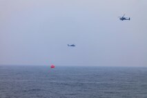 Two U.S. Army AH-64E Apache attack helicopters assigned to U.S. Army Central Command’s (USARCENT) Task Force Saber hover over an inflatable target during a live-fire training exercise with ships assigned to U.S. Naval Forces Central Command (USNAVCENT) in the North Arabian Gulf. Task Force Saber provides reconnaissance, surveillance, logistical support and offensive strike capabilities while supporting partner forces.