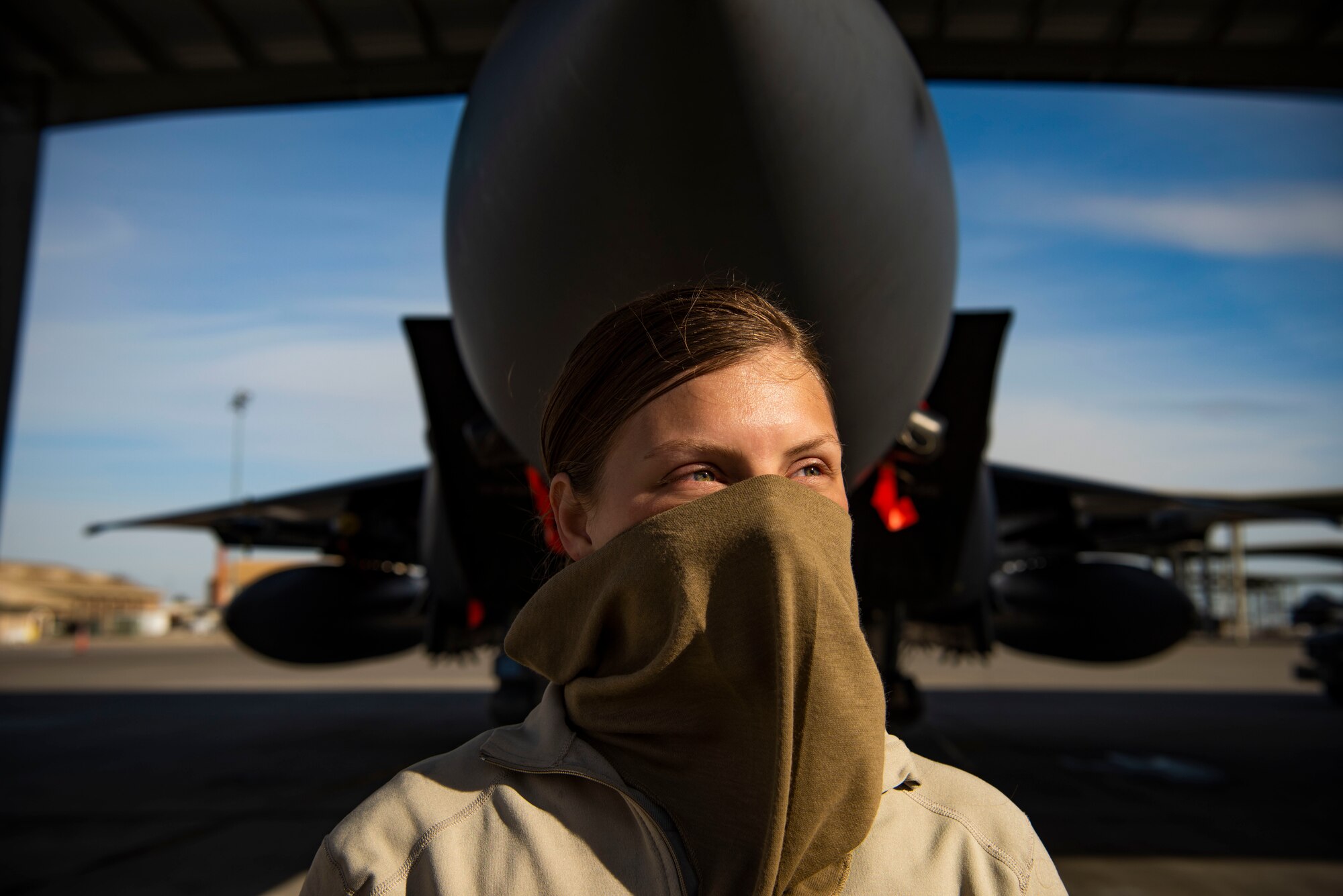 U.S. Air Force Airman 1st Class Kristin Lyons, 391st Fighter Squadron crew chief, wears a cloth mask while working during the COVID-19 pandemic, April 14, 2020, at Mountain Home Air Force Base, Idaho. 391st FS Airmen are working in two teams with a week-on and week-off schedule to avoid the potential spread of COVID-19. (U.S. Air Force photo by Airman 1st Class Andrew Kobialka)