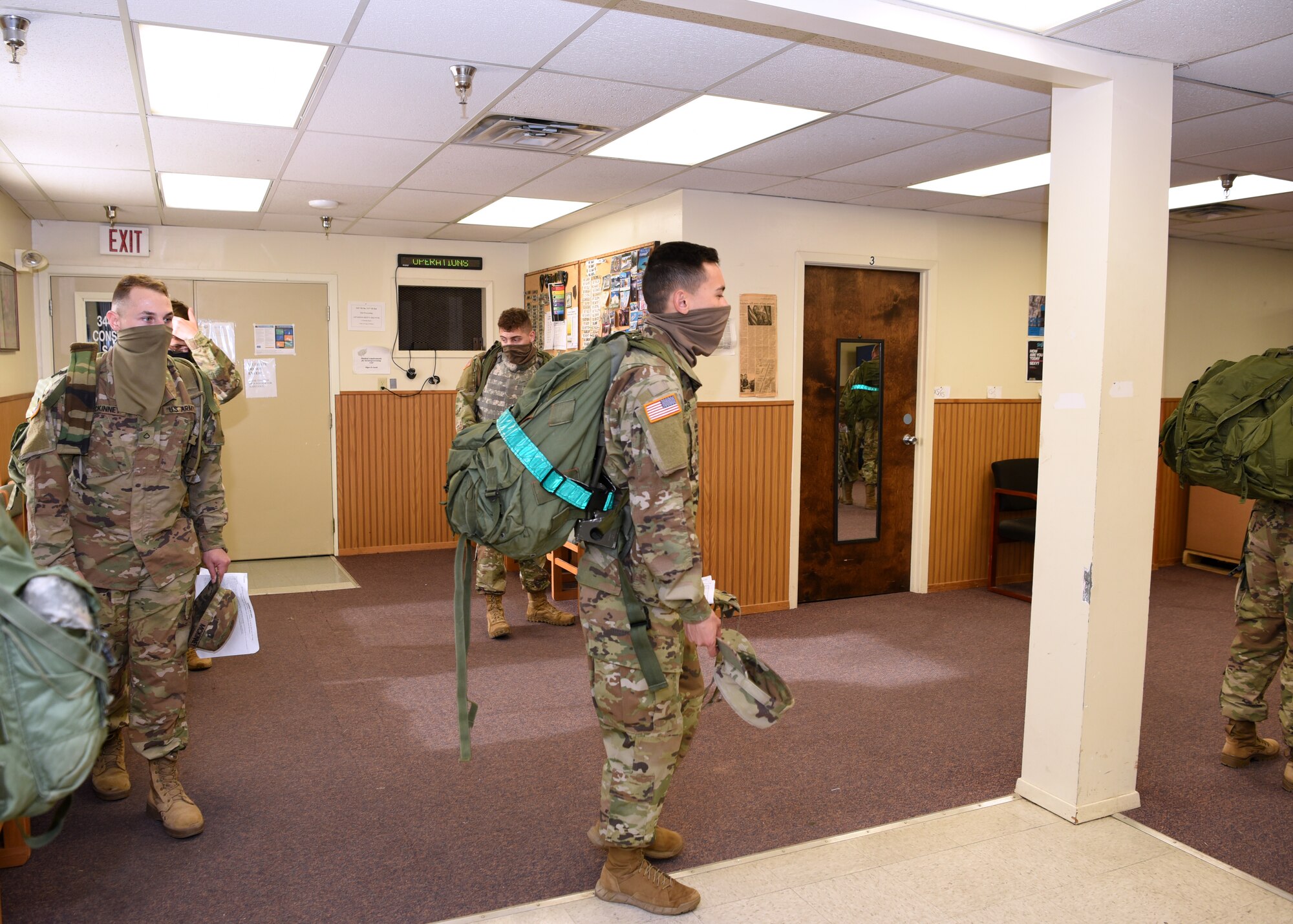 U.S. Army students from the 344th Military Intelligence Battalion adhere to COVID-19 social distance and mask wearing measures while waiting to return their field equipment inside the 344th MI BN Supply building, on Goodfellow Air Force Base, Texas, April 20, 2020. Goodfellow continued to train, develop and inspire the future force by practicing safety measures. (U.S. Air Force photo by Airman 1st Class Abbey Rieves)