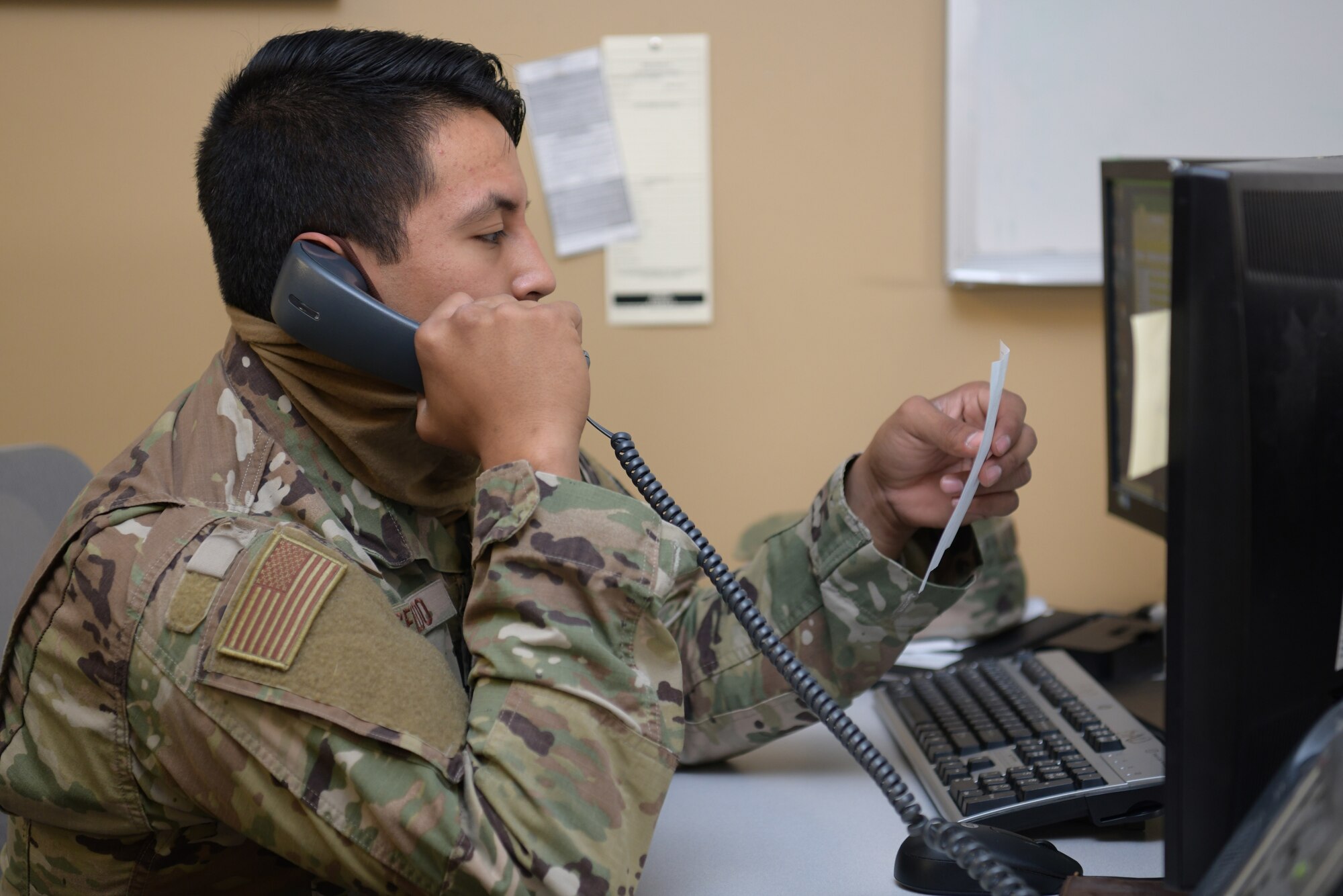 Airman speaks on the phone.