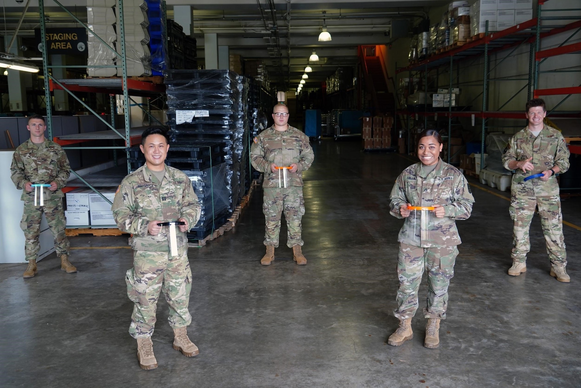 U.S. Air Force Airmen and U.S. Army Soldiers pose with 3D printed masks that were donated to the Tripler Army Medical Hospital, Hawaii, April 3, 2020. The 15th Wing donated the face
shields in response to a personal protective equipment shortage to ensure medical staff across the island stay protected from the COVID-19 pandemic. (U.S. Air Force photo by Airman 1st Class Erin Baxter)