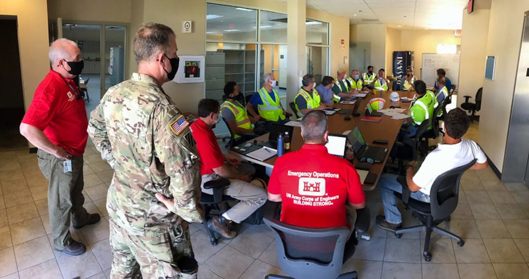 Col. Daniel Hibner (left), Savannah District Commander, and Erik Blechinger, District Deputy Engineer, address members of Conti Federal Services, Inc., the contractor converting the Regional Training Institute barracks into a alternate care facility for COVID-19 on St. Croix Island, April 20, 2020.