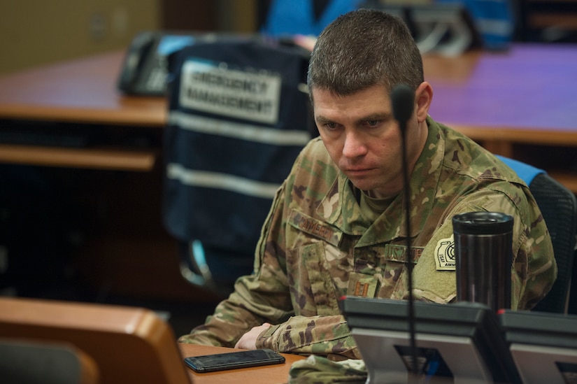 Capt. Shawn Cameron, 628th Logistics Readiness Squadron operations officer and COVID-19 Working Group member, reviews updates on COVID-19 response tasks at the Emergency Operations Center located at Joint Base Charleston, S.C., April 16, 2020. Through the collaboration of ideas and perspectives, the group’s mission is to create possible solutions and generate recommendations for JB Charleston leaders. Their work allows commanders to make sound decisions affecting the installation and mission during the global pandemic.