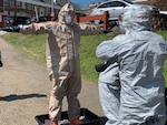 A member of the West Virginia National Guard Task Force CRE undergoes decontamination following COVID-19 testing at a veterans home facility April 20, 2020. The West Virginia National Guard tested more than 400 patients and staff at two veterans home facilities in Barboursville and Clarksburg.
