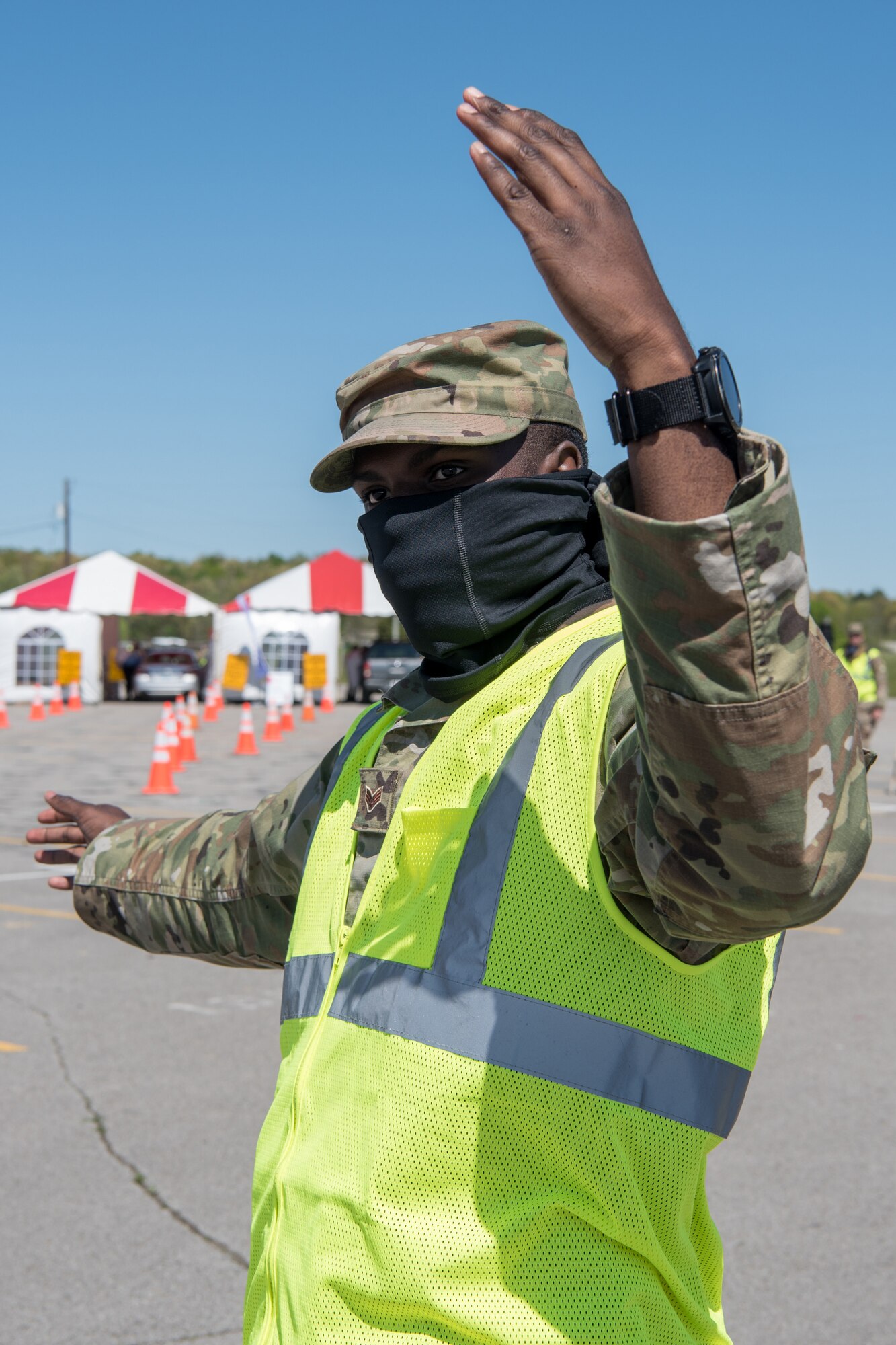 Senior Airman Keontay Curry, a communications specialist for the Kentucky Air National Guard’s 123rd Contingency Response Group, directs patients through a drive-through testing station for COVID-19 in Madisonville, Ky., April 21, 2020. Kentucky Air Guardsmen will be supporting multiple testing sites across the state. (U.S. Air National Guard photo by Staff Sgt. Joshua Horton)