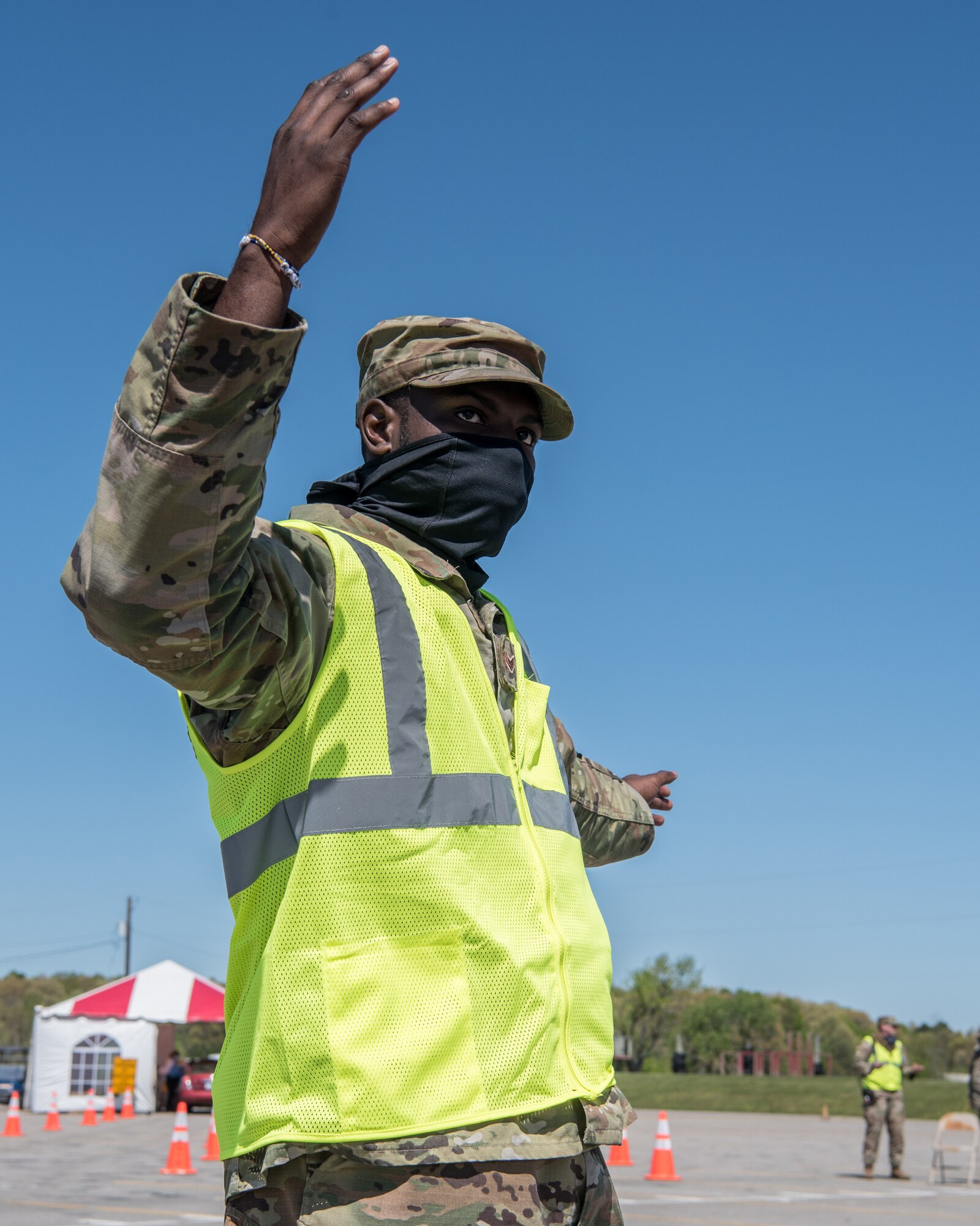 Senior Airman Keontay Curry, a communications specialist for the Kentucky Air National Guard’s 123rd Contingency Response Group, directs patients through a drive-through testing station for COVID-19 in Madisonville, Ky., April 21, 2020. Kentucky Air Guardsmen will be supporting multiple testing sites across the state. (U.S. Air National Guard photo by Staff Sgt. Joshua Horton)