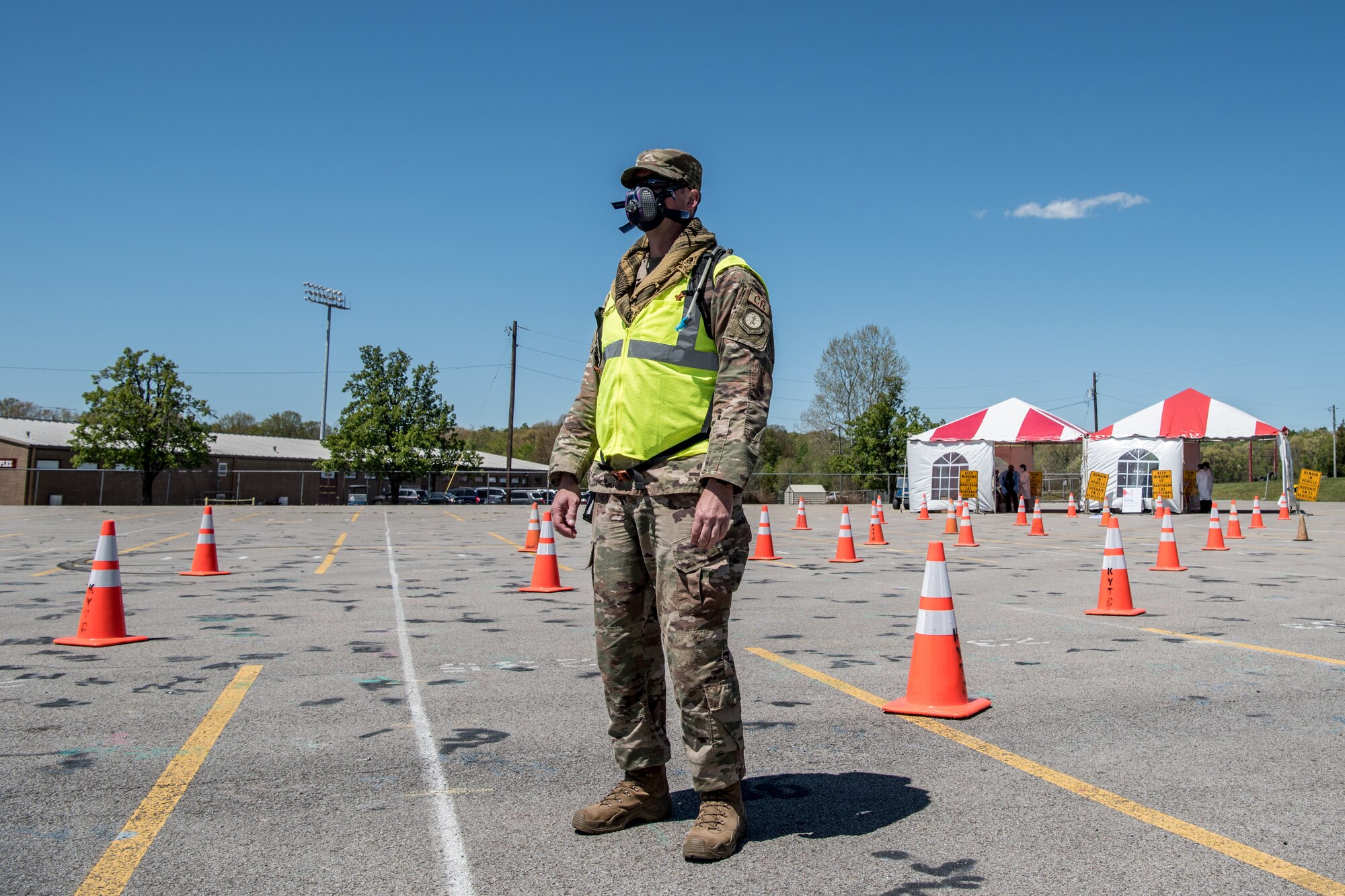 Master Sgt. Jason Michel, a security forces specialist for the Kentucky Air National Guard’s 123rd Contingency Response Group, directs patients through a drive-through testing station for COVID-19 in Madisonville, Ky., April 21, 2020. Kentucky Air Guardsmen will be supporting multiple testing sites across the state. (U.S. Air National Guard photo by Staff Sgt. Joshua Horton)