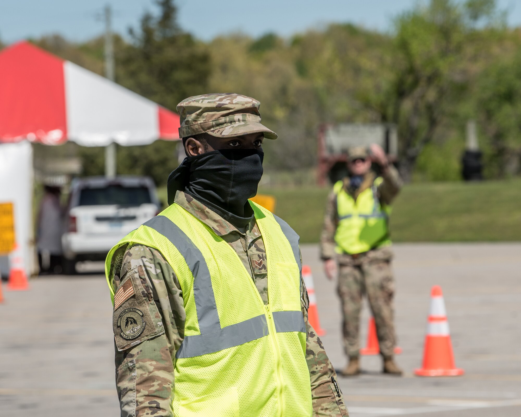 Senior Airman Keontay Curry, a communications specialist for the Kentucky Air National Guard’s 123rd Contingency Response Group, directs patients through a drive-through testing station for COVID-19 in Madisonville, Ky., April 21, 2020. Kentucky Air Guardsmen will be supporting multiple testing sites across the state. (U.S. Air National Guard photo by Staff Sgt. Joshua Horton)