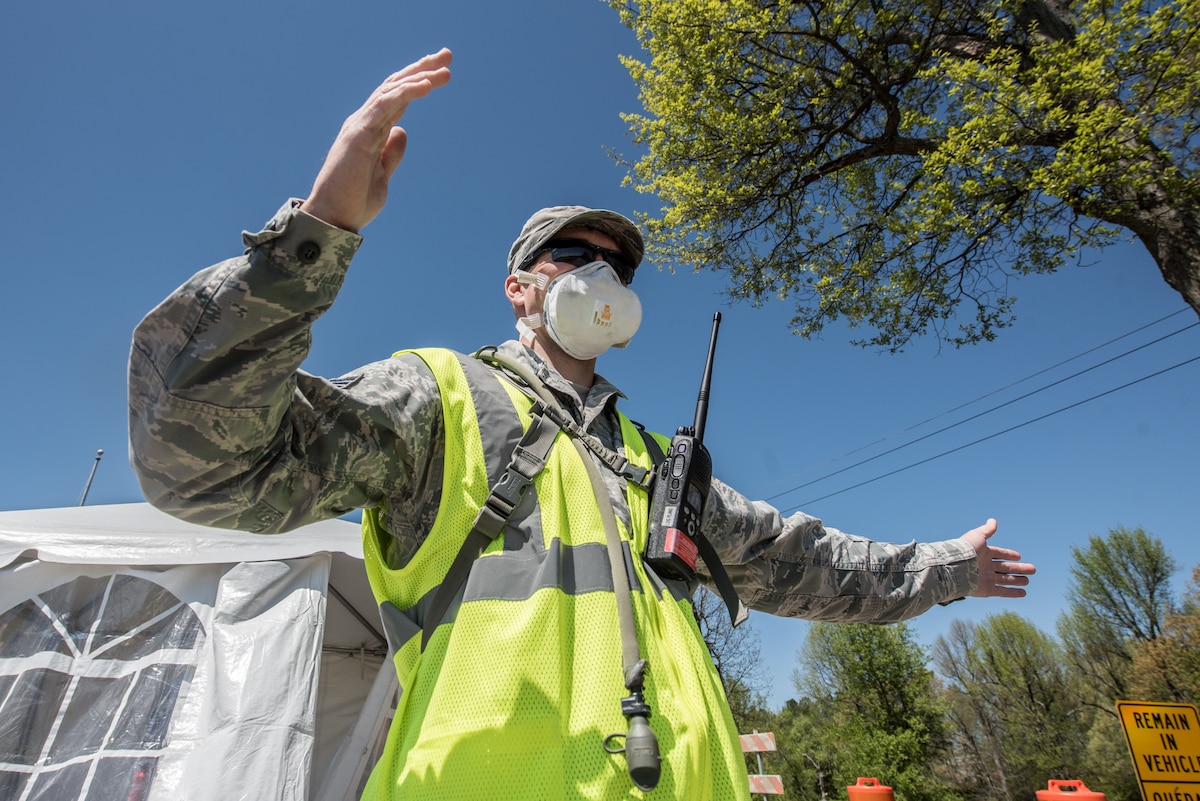 Tech. Sgt. Abe Hilbers, an engineering assistant for the Kentucky Air National Guard’s 123rd Contingency Response Group, directs patients through a drive-through testing station for COVID-19 in Madisonville, Ky., April 21, 2020. Kentucky Air Guardsmen will be supporting multiple testing sites across the state. (U.S. Air National Guard photo by Staff Sgt. Joshua Horton)