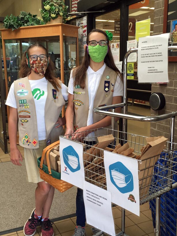 Kolleen, left, and Karina Roessig stand next to the bin of free face masks at the Arnold Air Force Commissary. Arnold Engineering Development Complex Commander Col. Jeffrey Geraghty, in line with the Defense Commissary Agency’s guidance, issued a directive that effective April 10 all Base Exchange and Commissary patrons must wear face coverings while in the facilities. The donated masks include ones made by the Roessig sisters. (Courtesy photo)
