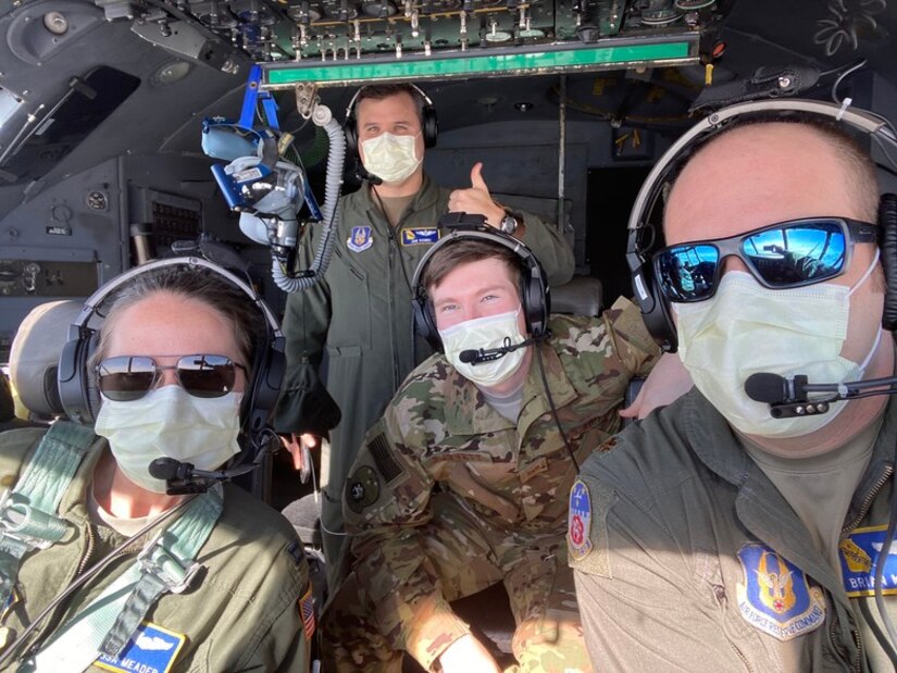 crew members on a Dobbins C-130H3 Hercules pose for a photo wearing masks on April 5, 2020. They transported five Air Force Reserve medical personnel to Joint Base McGuire-Dix-Lakehurst, New Jersey, to join the effort in combating COVID-19 in New York City. The Dobbins C-130H also made stops at MacDill Air Force Base and Patrick AFB in Florida, and Charleston AFB, South Carolina to pick up more Reserve Citizen Airmen to join the fight. Pictured from left to right, clockwise, are Capt. Latessa Meader, co-pilot; Maj. Jonathan Bonde, navigator; Tech. Sgt. Joey Burnett, flight engineer; and Maj. Brian Metzger, aircraft commander