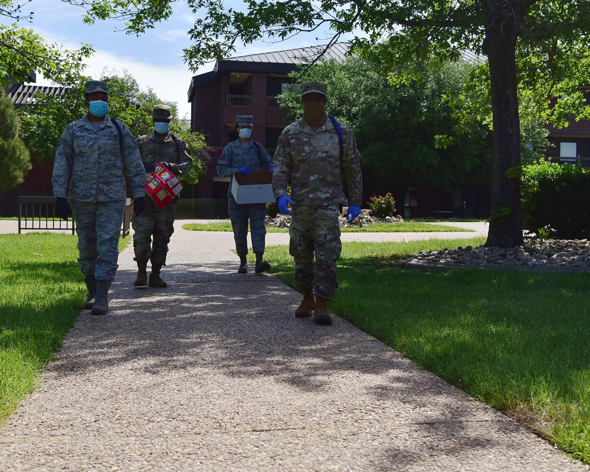 Volunteers deliver care packages to 17th Training Wing members in isolation on Goodfellow Air Force Base, Texas, April 20, 2020. The volunteers delivered dozens of care packages full of snacks to members in isolation as part of a joint initiative with the local community to ensure the inbound members are taken care of. (U.S. Air Force photo by Staff Sgt. Chad Warren)