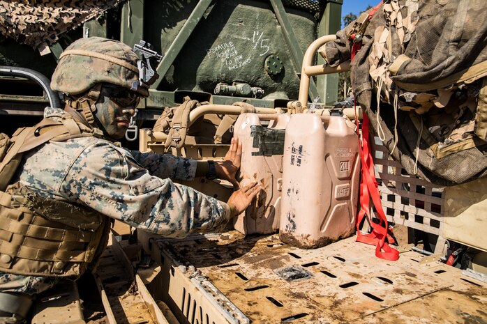 U.S. Marine Corps Lance Cpl. Joseph Sison, a rifleman with 1st Battalion, 5th Marine Regiment, 1st Marine Division, pushes water jugs onto a vehicle during the Marine Corps Combat Readiness Evaluation (MCCRE) on Marine Corps Base Camp Pendleton, California, Sept. 17, 2019. 5th Marines conducted a regimental-sized MCCRE that included 1st Battalion, 5th Marines, 2nd Battalion, 5th Marines, and the Regimental Headquarters to increase the combat proficiency and readiness of the regiment. The MCCRE took place over a 10-day period and served as a proof of concept for future regimental-sized MCCREs. (U.S. Marine Corps photo by Lance Cpl. Alexa M. Hernandez)