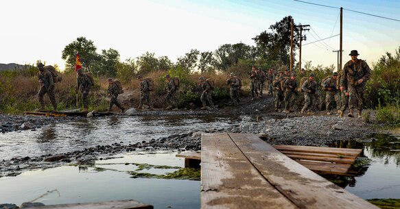 U.S. Marines with 2nd Battalion, 5th Marine Regiment, 1st Marine Division, hike during a Marine Corps Combat Readiness Evaluation (MCCRE) on Marine Corps Base Camp Pendleton, California, Sept. 18, 2019. 5th Marines conducted a regimental-sized MCCRE for 1st Battalion, 5th Marines and 2nd Battalion, 5th Marines, as well as the Regimental Headquarters to increase the combat proficiency and readiness of the regiment. The MCCRE took place over a 10 day period and served as proof of concept for future regimental-sized MCCREs. (U.S. Marine Corps photo by Lance Cpl. Roxanna Ortiz)