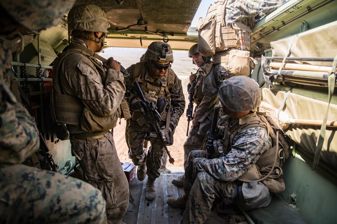 U.S. Navy HM2 Andrew Franco, center, a corpsman with 1st Battalion, 5th Marine Regiment, 1st Marine Division, enters an Amphibious Assault Vehicle during the Marine Corps Combat Readiness Evaluation (MCCRE) on Marine Corps Base Camp Pendleton, California, Sept. 18, 2019. 5th Marines conducted a regimental-sized MCCRE that included 1st Battalion, 5th Marines, 2nd Battalion, 5th Marines, and the Regimental Headquarters to increase the combat proficiency and readiness of the regiment. The MCCRE took place over a 10-day period and served as a proof of concept for future regimental-sized MCCREs. (U.S. Marine Corps photo by Lance Cpl. Alexa M. Hernandez)