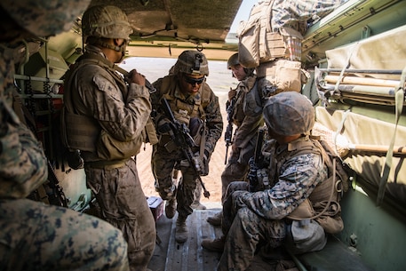 U.S. Navy HM2 Andrew Franco, center, a corpsman with 1st Battalion, 5th Marine Regiment, 1st Marine Division, enters an Amphibious Assault Vehicle during the Marine Corps Combat Readiness Evaluation (MCCRE) on Marine Corps Base Camp Pendleton, California, Sept. 18, 2019. 5th Marines conducted a regimental-sized MCCRE that included 1st Battalion, 5th Marines, 2nd Battalion, 5th Marines, and the Regimental Headquarters to increase the combat proficiency and readiness of the regiment. The MCCRE took place over a 10-day period and served as a proof of concept for future regimental-sized MCCREs. (U.S. Marine Corps photo by Lance Cpl. Alexa M. Hernandez)