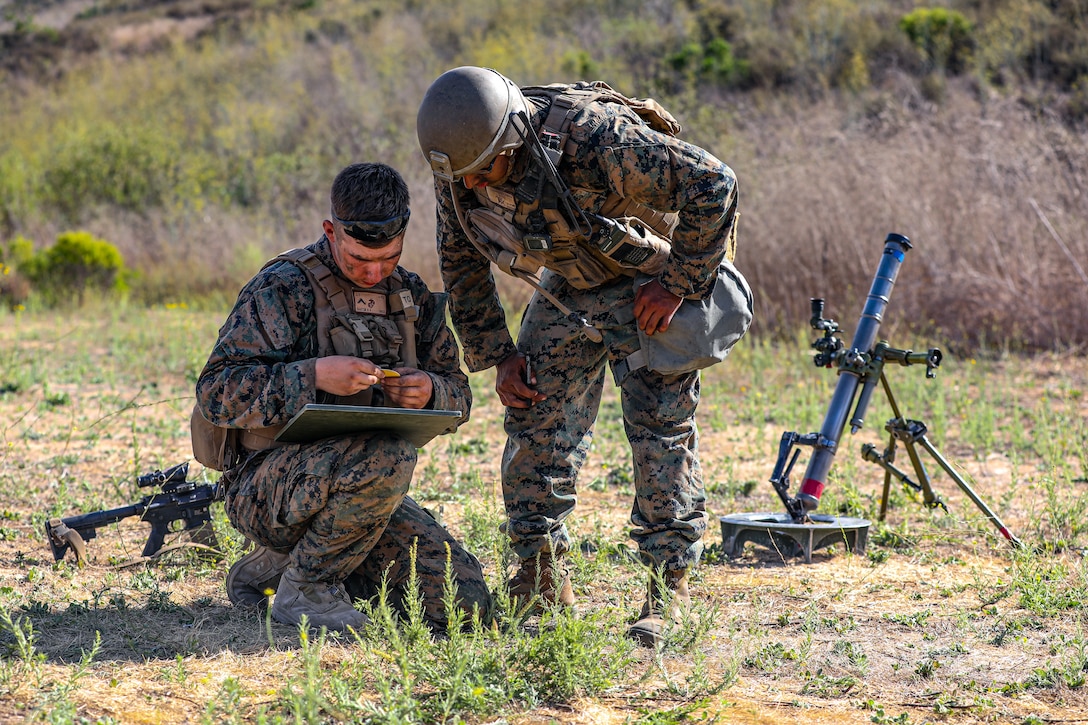 U.S. Marine Corps Cpl. Edgar Barajachavez, right, a squad leader instructs Pfc. Brock Barton, a mortarman, both with 2nd Battalion, 5th Marine Regiment, 1st Marine Division, during a Marine Corps Combat Readiness Evaluation (MCCRE) on Marine Corps Base Camp Pendleton, California, Sept. 22, 2019. 5th Marines conducted a regimental-sized MCCRE for 1st Battalion, 5th Marines and 2nd Battalion, 5th Marines, as well as the Regimental Headquarters to increase the combat proficiency and readiness of the regiment. The MCCRE took place over a 10 day period and served as proof of concept for future regimental-sized MCCREs. (U.S. Marine Corps photo by Lance Cpl. Roxanna Ortiz)