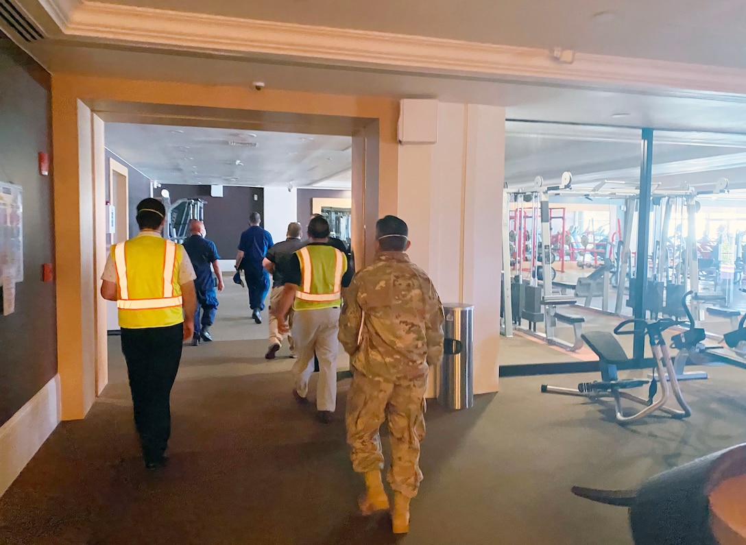 Representatives from the U.S. Army Corps of Engineers (USACE), Honolulu District, the government of Guam, the Federal Emergency Management Agency (FEMA), NAVFAC Marianas, U.S. Department Health and Human Services, and 18th MEDCOM evaluate the fitness center and meeting room spaces in the Hilton Guam Resort & Spa  for potential us as an Alternate Care Facility.