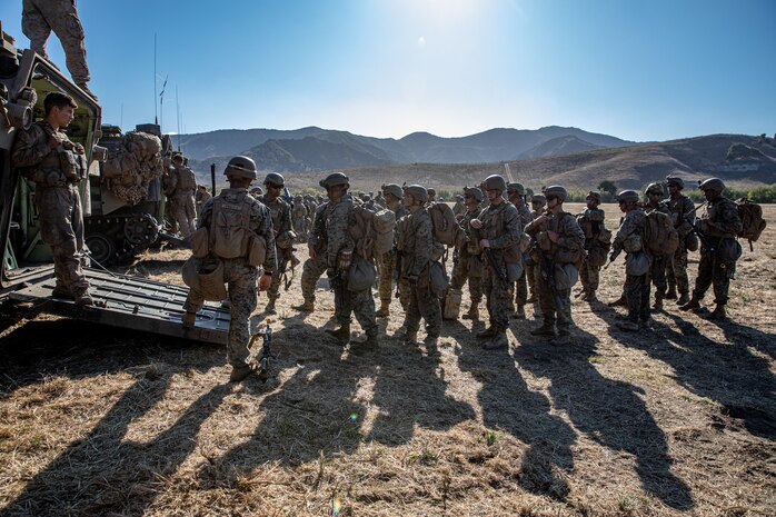 U.S. Marines with 2nd Battalion, 5th Marine Regiment, 1st Marine Division,  prepare to enter an assault amphibious vehicle during a Marine Corps Combat Readiness Evaluation (MCCRE) on Marine Corps Base Camp Pendleton, California, Sept. 23, 2019. 5th Marines conducted a regimental-sized MCCRE for 1st Battalion, 5th Marines and 2nd Battalion, 5th Marines, as well as the Regimental Headquarters to increase the combat proficiency and readiness of the regiment. The MCCRE took place over a 10 day period and served as proof of concept for future regimental-sized MCCREs. (U.S. Marine Corps photo by Lance Cpl. Roxanna Ortiz)