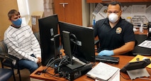 Future Soldier, Specialist Tyler Morris, works with Sergeant First Class Joseph Ventura during the final phases of entrance into the U.S. Army at the San Diego military Entrance Processing Facility April 21, 2020. Morris will become a 74D, or a Chemical, Biological Radiological and Nuclear Specialist and is adhering to COVID-19 precautions by maintaining six feet of distance from MEPS employees and wearing personal protective equipment. (USAREC Photo)