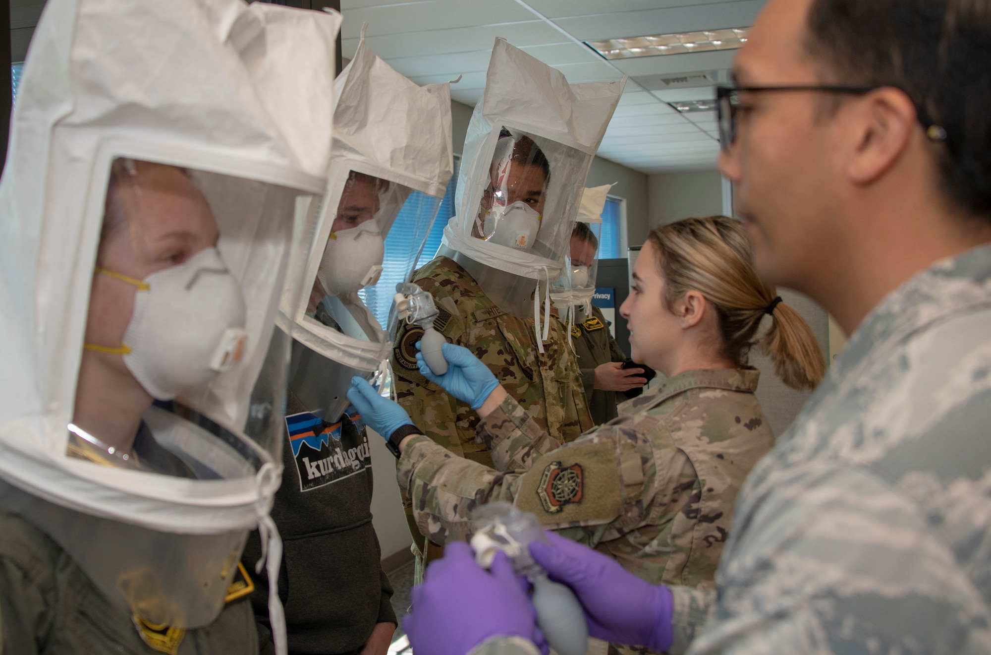 60th Aerospace Medicine Squadron Bioenvironmental Engineering Flight technicians perform N95 mask fit tests on aircrew members April 10, 2020, at Travis Air Force Base, California. The bioenvironmental engineering flights conducts respirator and gas mask fit tests to protect Airmen and maintain a healthy workforce. They also perform environmental, occupational and radiological surveillance. (U.S. Air Force photo by Heide Couch)
