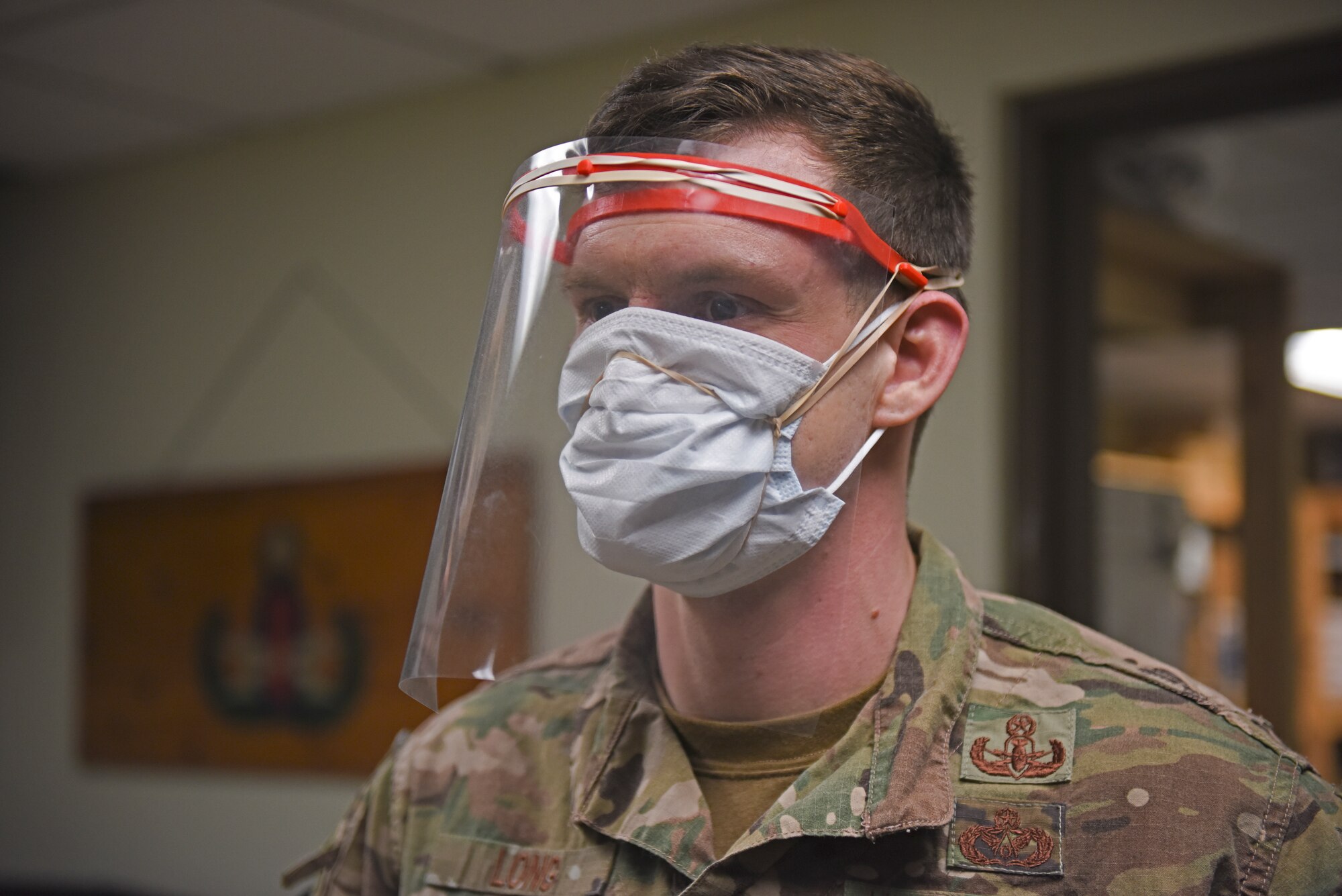 U.S. Air Force Master Sgt. Devin Long, 8th Civil Engineer Squadron explosive ordnance disposal flight chief, dons the second prototype of the protective plastic face shield at Kunsan Air Base, Republic of Korea, April 20, 2020. EOD created two initial face shield designs, working closely with the 8th Medical Group to ensure the design both protects Airmen and prevents the spread of the disease. (U.S. Air Force photo by Staff Sgt. Mackenzie Mendez)