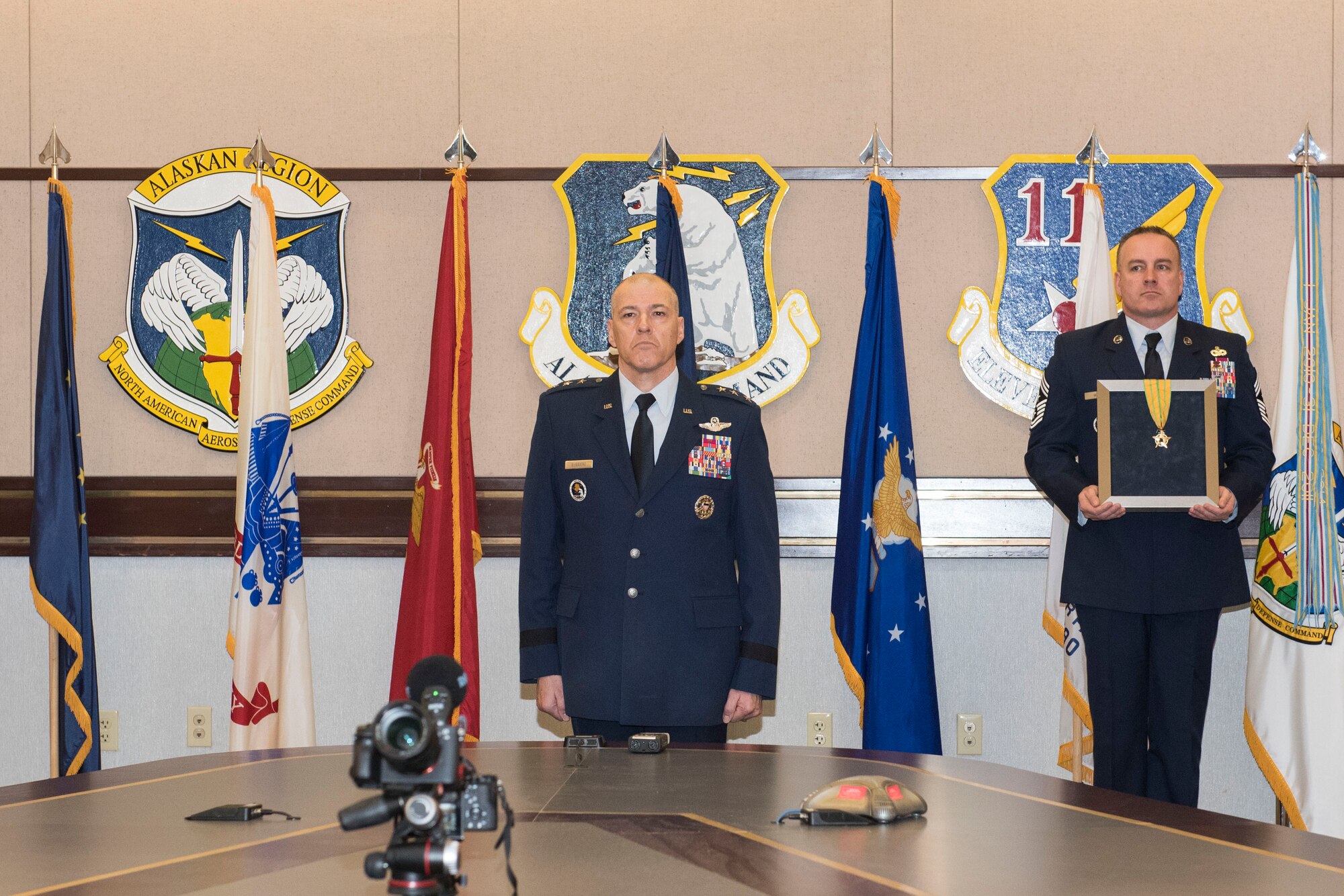 U.S. Air Force Lt. Gen. Thomas A. Bussiere is awarded the Alaska Legion of Merit during a change of command ceremony April 20, 2020, at Joint Base Elmendorf-Richardson, Alaska. Bussiere received the medal from Mike Dunleavy, Governor of the state of Alaska, who was unable to attend the event. The Alaska Legion of Merit medal honors members who carry out extraordinarily distinguished or meritorious service on behalf of the State. Due to physical restrictions of the ongoing COVID-19 pandemic, the virtual change of command ceremony was presided over via video teleconference by Air Force Gen. Terrence O’Shaughnessy, commander of the North American Aerospace Defense Command and United States Northern Command, and Air Force Gen. Charles Q. Brown, Pacific Air Forces commander.