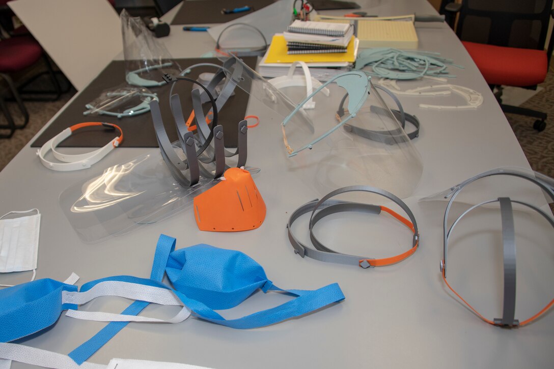 Personal protective equipment prototypes are displayed on a table at the 60th Aerospace Medicine Squadron, Bioenvironmental Engineering Flight April 8, 2020, at Travis Air Force Base, California. The bioenvironmental engineering flight, 60th Dental Squadron, 60th Air Mobility Wing Phoenix Spark innovation cell and 60th Maintenance Squadron collaborated to design personal protective equipment for David Grant USAF Medical Center. (U.S. Air Force photo by Heide Couch)