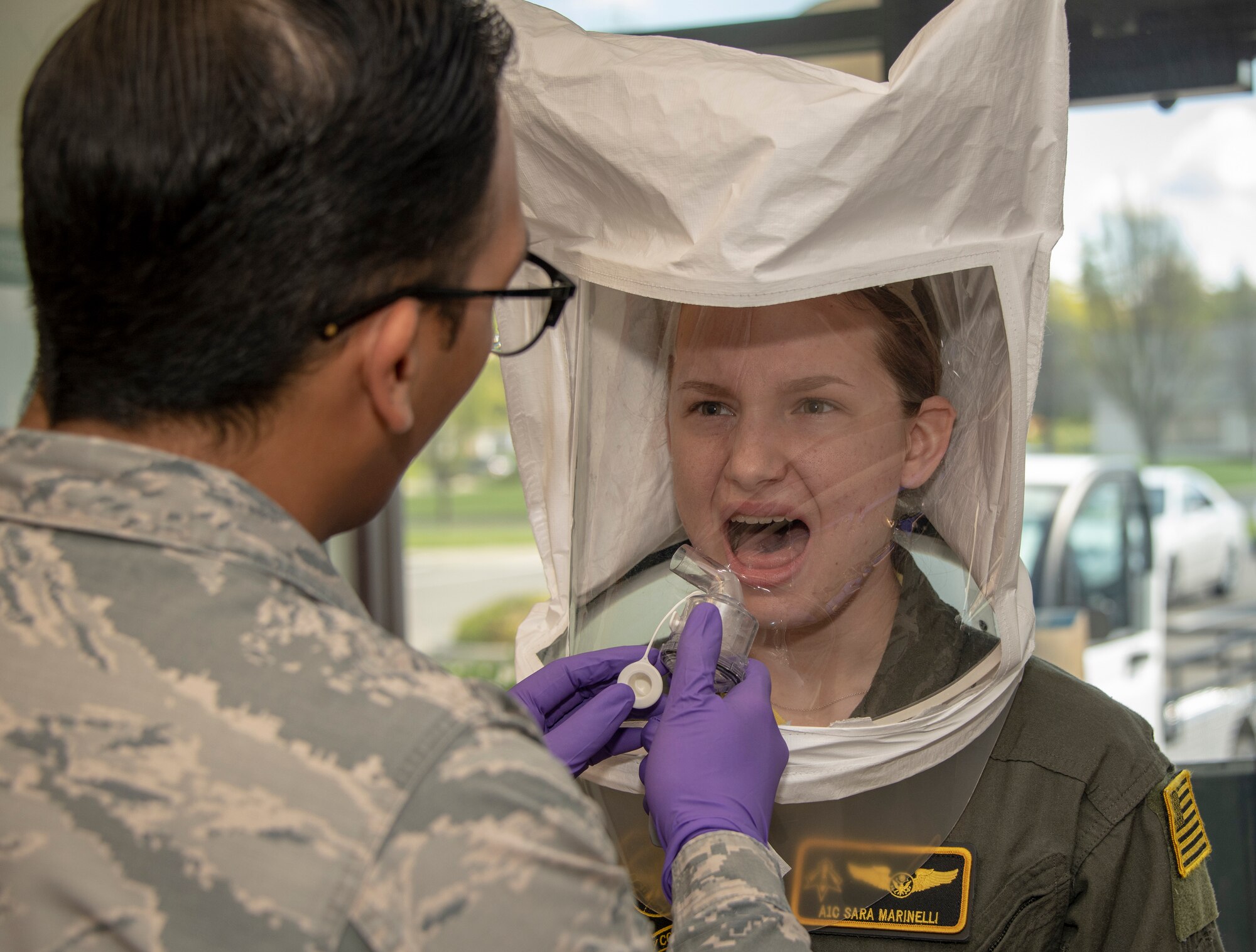 U.S. Air Force Airman 1st Class Jeffrey Cruz, 60th Aerospace Medicine Squadron Bioenvironmental Engineering Flight technician, conducts a fit test on Airman 1st Class Sara Marinelli, 21st Airlift Squadron loadmaster, April 10, 2020, at Travis Air Force Base, California. The bioenvironmental engineering flights conducts respirator and gas mask fit tests to protect Airmen and maintain a healthy workforce. They also perform environmental, occupational and radiological surveillance. (U.S. Air Force photo by Heide Couch)