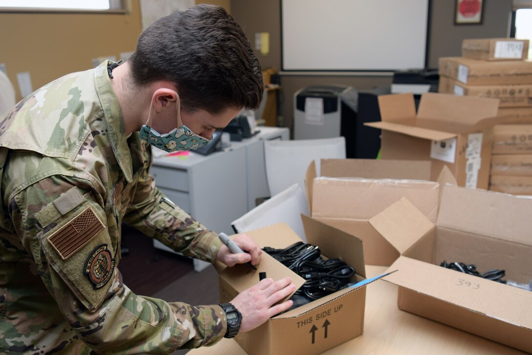 Airman writes on box.