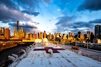 The New York City skyline serves as a backdrop to a moored hospital ship.