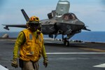 An F-35B Lightning II fighter aircraft with Marine Medium Tiltrotor Squadron (VMM) 265 (Reinforced), 31st Marine Expeditionary Unit (MEU), prepares to take off from the flight deck of amphibious assault ship USS America (LHA 6). VMM-265 (Rein.), with F-35Bs from Marine Fighter Attack Squadron 121, is currently serving as the aviation combat element for the 31st MEU. America, flagship of the America Expeditionary Strike Group, 31st MEU team, is operating in the U.S 7th Fleet area of operations to enhance interoperability with allies and partners and serve as a ready response force to defend peace and stability in the Indo-Pacific region.