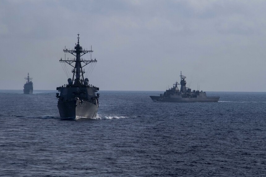 Royal Australian Navy guided-missile frigate HMAS Parramatta (FFH 154), right, sails with U.S. Navy amphibious assault ship USS America (LHA 6), Ticonderoga-class guided missile cruiser USS Bunker Hill (CG 52) and Arleigh Burke-class guided missile destroyer USS Barry (DDG 52). America, flagship of the America Expeditionary Strike Group, 31st Marine Expeditionary Unit team, is operating in the U.S. 7th Fleet area of operations to enhance interoperability with allies and partners and serve as a ready response force to defend peace and stability in the Indo-Pacific region.