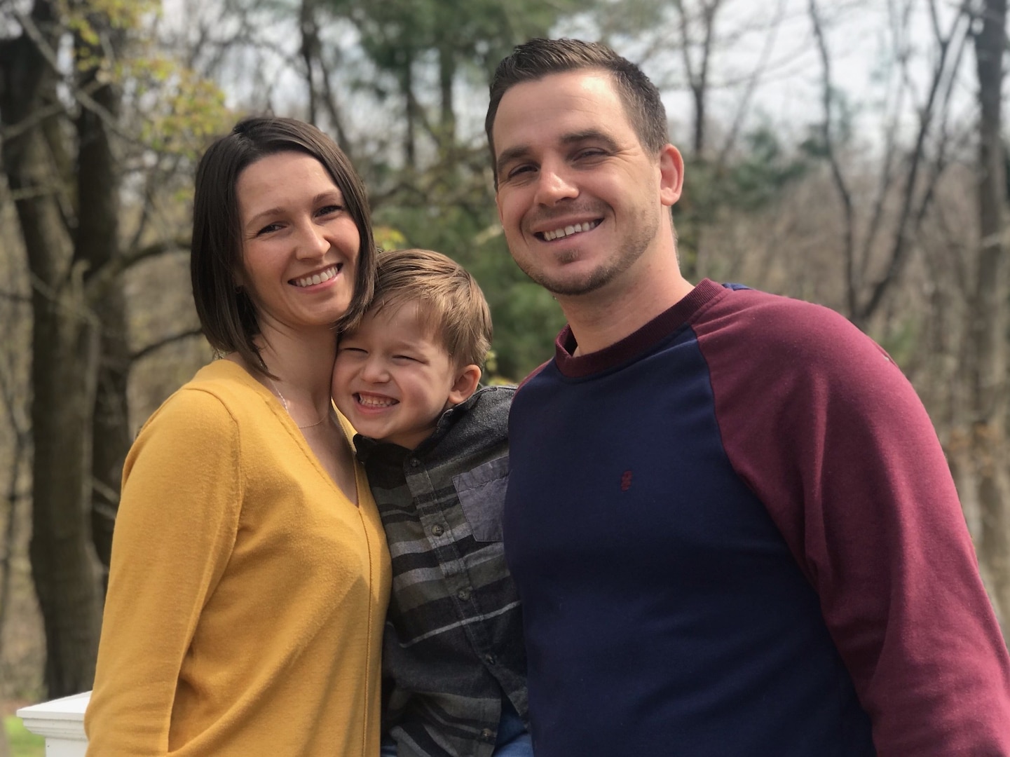 Sorina Prian-Tanczos, a DLA Troop Support Industrial Hardware employee, poses in front of a wooded area with her husband and son April 17, 2020.