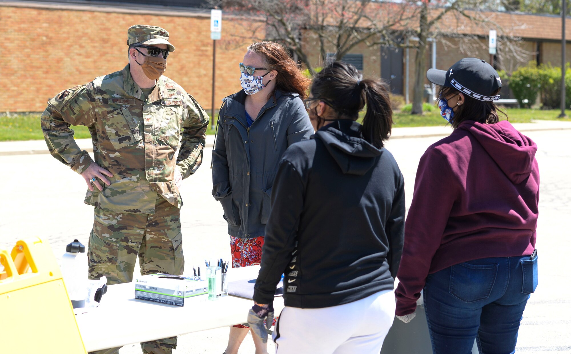 U.S. Air Force Col. Michael Phillips, 88th Air Base Wing vice commander, talks with volunteers manning a donation drop off point outside the chapel located in the Prairies housing area at Wright-Patterson Air Force Base, Ohio, April 21, 2020. (U.S. Air Force photo/Wesley Farnsworth)