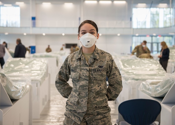 Connecticut Air National Guard Airman 1st Class Arielle Robles, 103rd Maintenance Group administration specialist, helps set up recovery center beds at Kaiser Hall at Central Connecticut State University in New Britain, Connecticut, April 21, 2020. Robles is an exercise science student at the university and is helping convert her usual classroom building into surge capacity space for local hospitals in response to the COVID-19 pandemic.