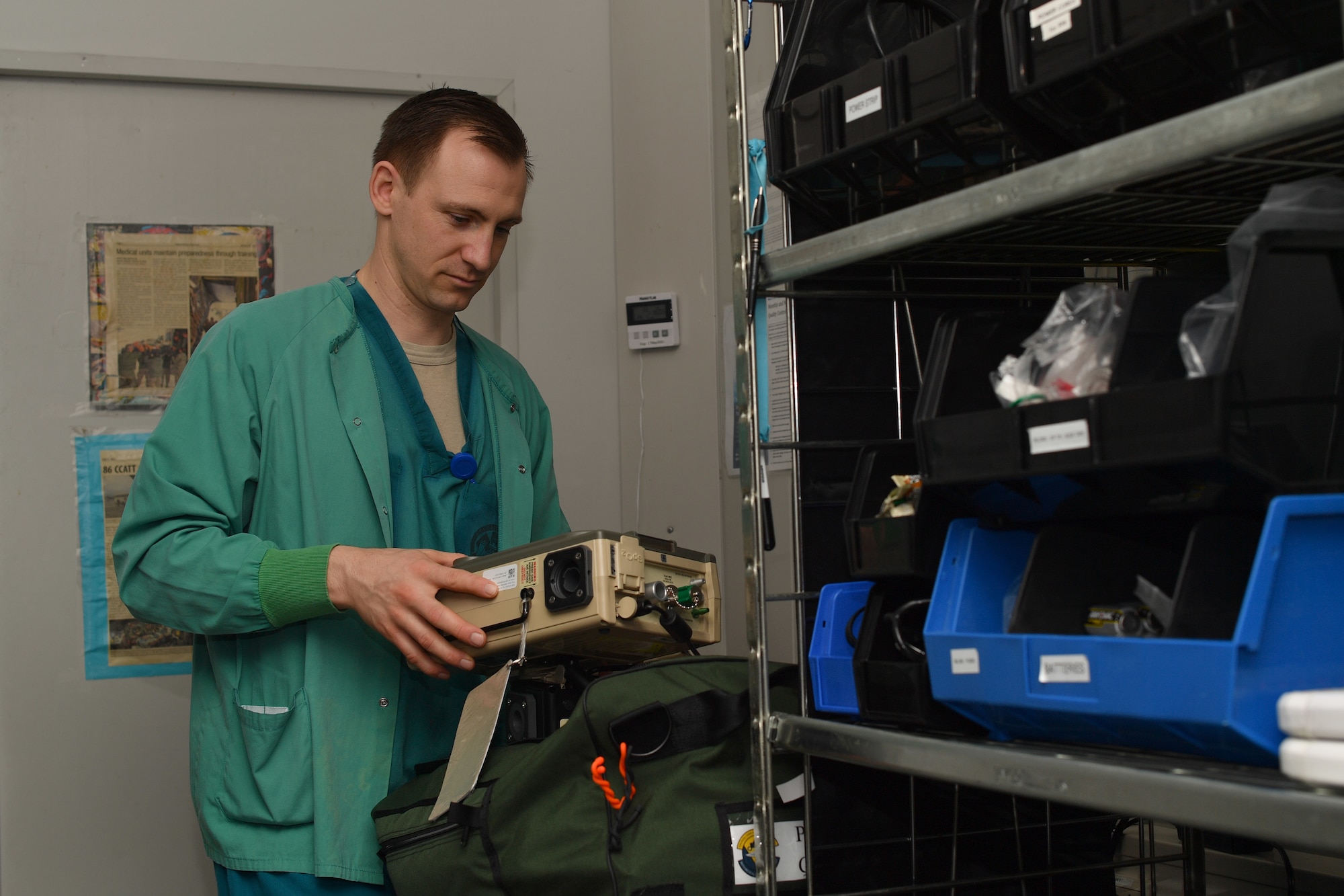 A medical worker holding medical equipment.