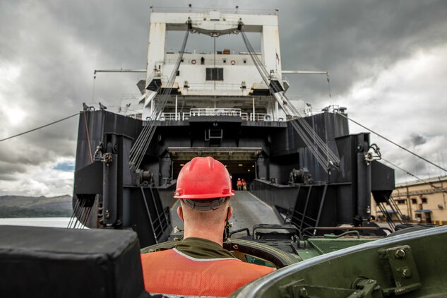 A U.S. Marine drives an amphibious assault vehicle onto the Watson-class vehicle cargo ship USNS Dahl during an operation to onload and offload equipment for construction of an Expeditionary Medical Facility April, 16.