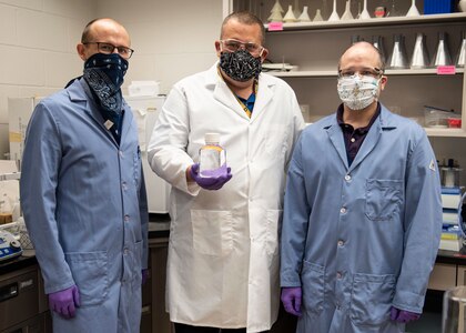 The Biotechnology Research and Development Laboratory team at Naval Surface Warfare Center Panama City Division is rapidly delivering hand sanitizer solutions to help personnel stop the spread of the COVID-19 virus.  Pictured from left to right: Dr. Travis Hand, Dr. Josh Kogot and Jeff Eichler.