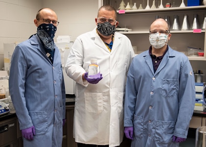 The Biotechnology Research and Development Laboratory team at Naval Surface Warfare Center Panama City Division is rapidly delivering hand sanitizer solutions to help personnel stop the spread of the COVID-19 virus.  Pictured from left to right: Dr. Travis Hand, Dr. Josh Kogot and Jeff Eichler.