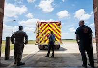 Members of the 628th Civil Engineer Squadron fire department watch firefighters train from a distance at North Auxiliary Airfield in North, S.C., April 17, 2020.