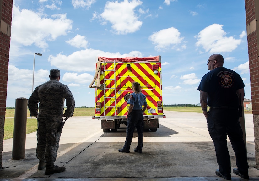 Members of the 628th Civil Engineer Squadron fire department watch firefighters train from a distance at North Auxiliary Airfield in North, S.C., April 17, 2020.