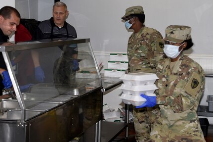 U.S. Army National Guard Soldiers with Joint Task Force 59, South Carolina National Guard, support Oliver Gospel in serving meals and maintaining social distancing for the homeless community in Columbia, South Carolina, April 14, 2020.