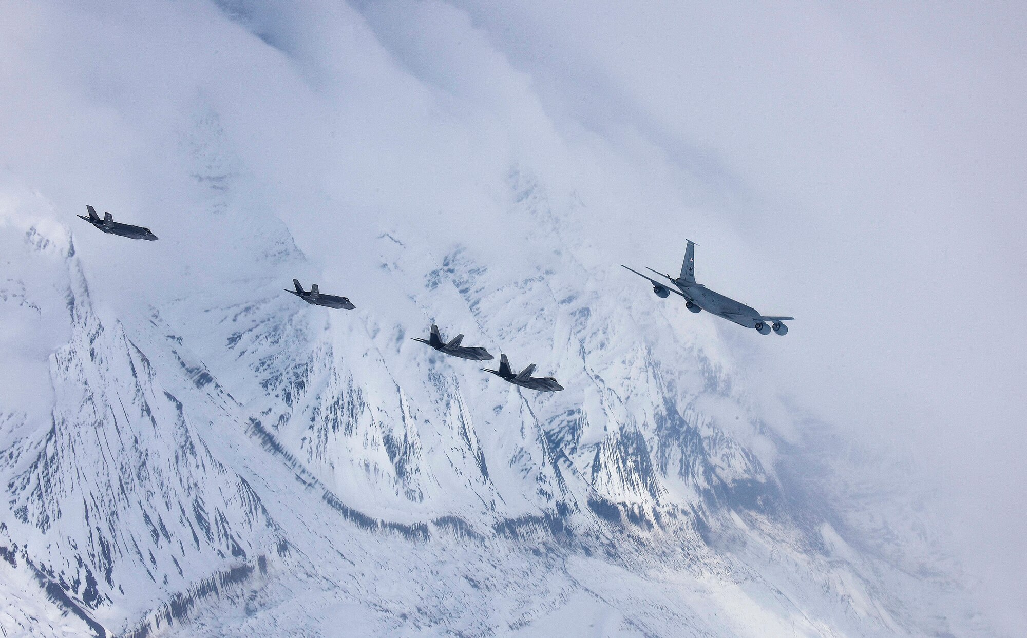 A five-ship formation of U.S. Air Force F-35A Lightning II and F-22 Raptor fifth-generation fighters and a KC-135R Stratotanker flies over the Joint Pacific Alaska Range Complex April 21, 2020.