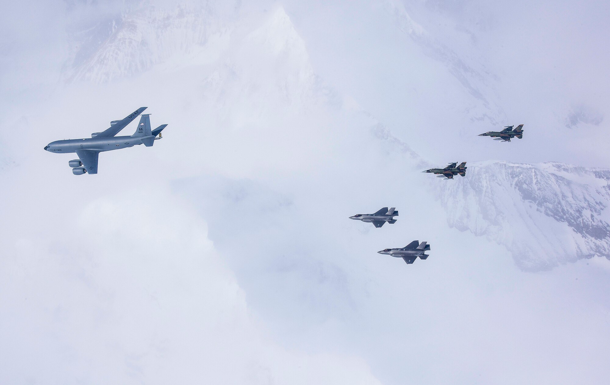 A five-ship formation of U.S. Air Force F-35A Lightning II, F-16C Fighting Falcon fighters and a KC-135R Stratotanker flies over the Joint Pacific Alaska Range Complex April 21, 2020.